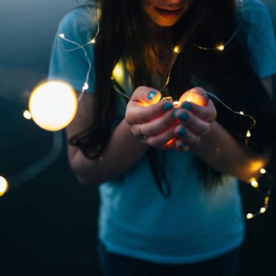 girl with lights in hands