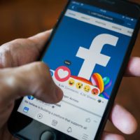 Bangkok, Thailand - March 17, 2018 : Facebook user touch on love button in Facebook application on iPhone 7.