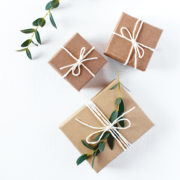 Craft gift boxes on white wooden background. Copy space for text. Eco concept