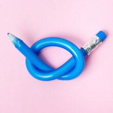 Flexible pencil on pink background. Bent pencils. Flexible business concept.